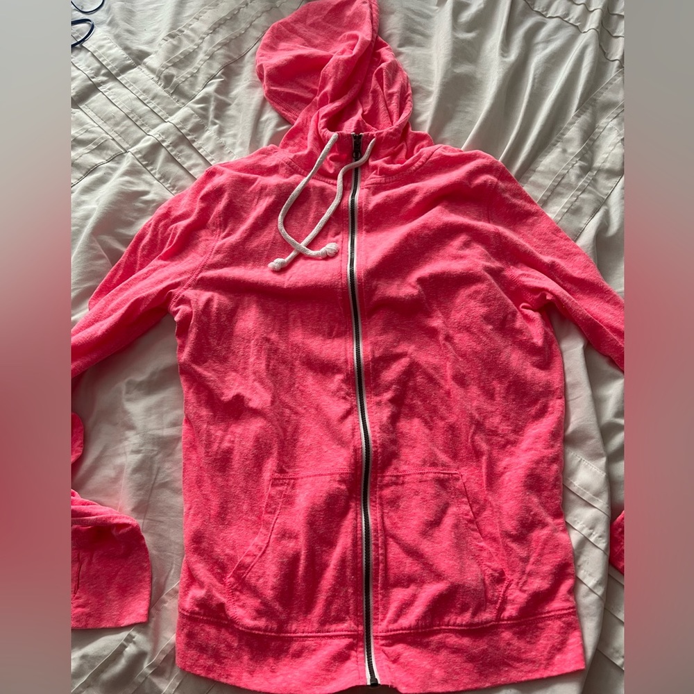 Thin, bright pink zip up hoodie.